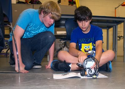 Students collaborate on the design and build of a robot.